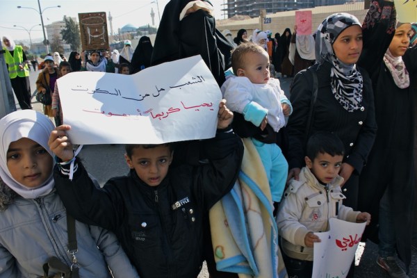 A family protests among the thousands who came out today to call for regime reform. The boy holds a sign that reads the same as a chant that rang out in the streets, "The people are tired of silence, live in dignity or die."