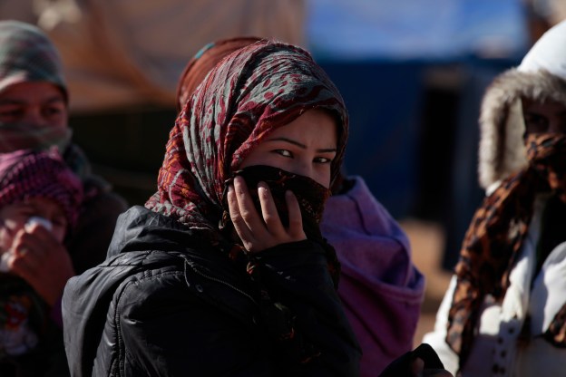 A young Syrian girl walks over to see what is being delivered by Lebanese for Syrians she and her friends were pleased to see the portable toilets being dropped off. There was no toilets or any sort of bathroom facilities. Photo by Omar Alkalouti.