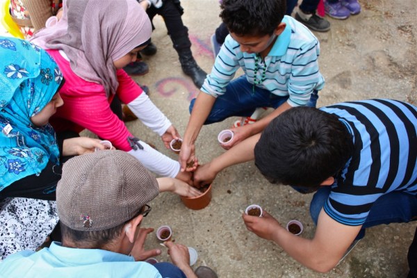 Syrian refugees from a nearby village learn how to plant basil seeds as part of Italian NGO Intersos’ psycho-social services that focus on diverse ways to educate children.