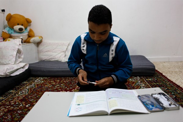 Alaa Haddad has his mathematics book out where he does his homework every night. Mathematics is his favorite subject.